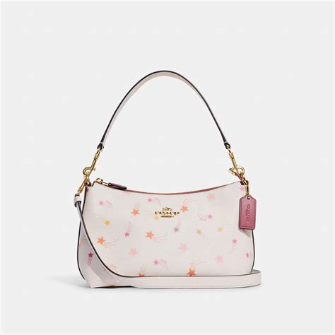 A timeless style that youll love and wear for years to come, this aptly named bag was dreamed up in the Coach Design Studio. . Coach pink purse